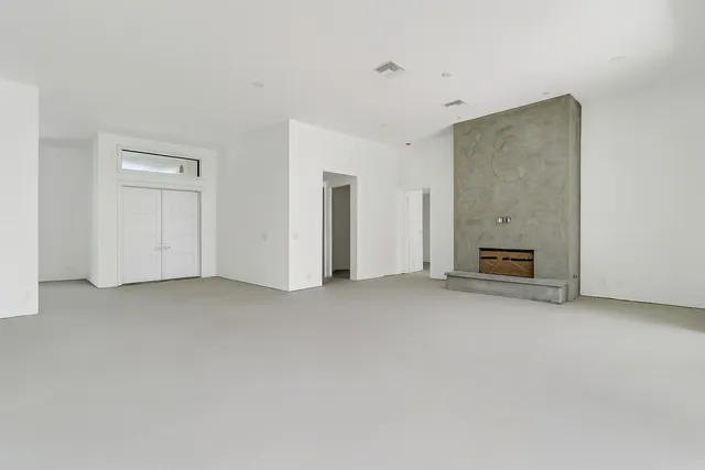 a view of empty room with a fireplace