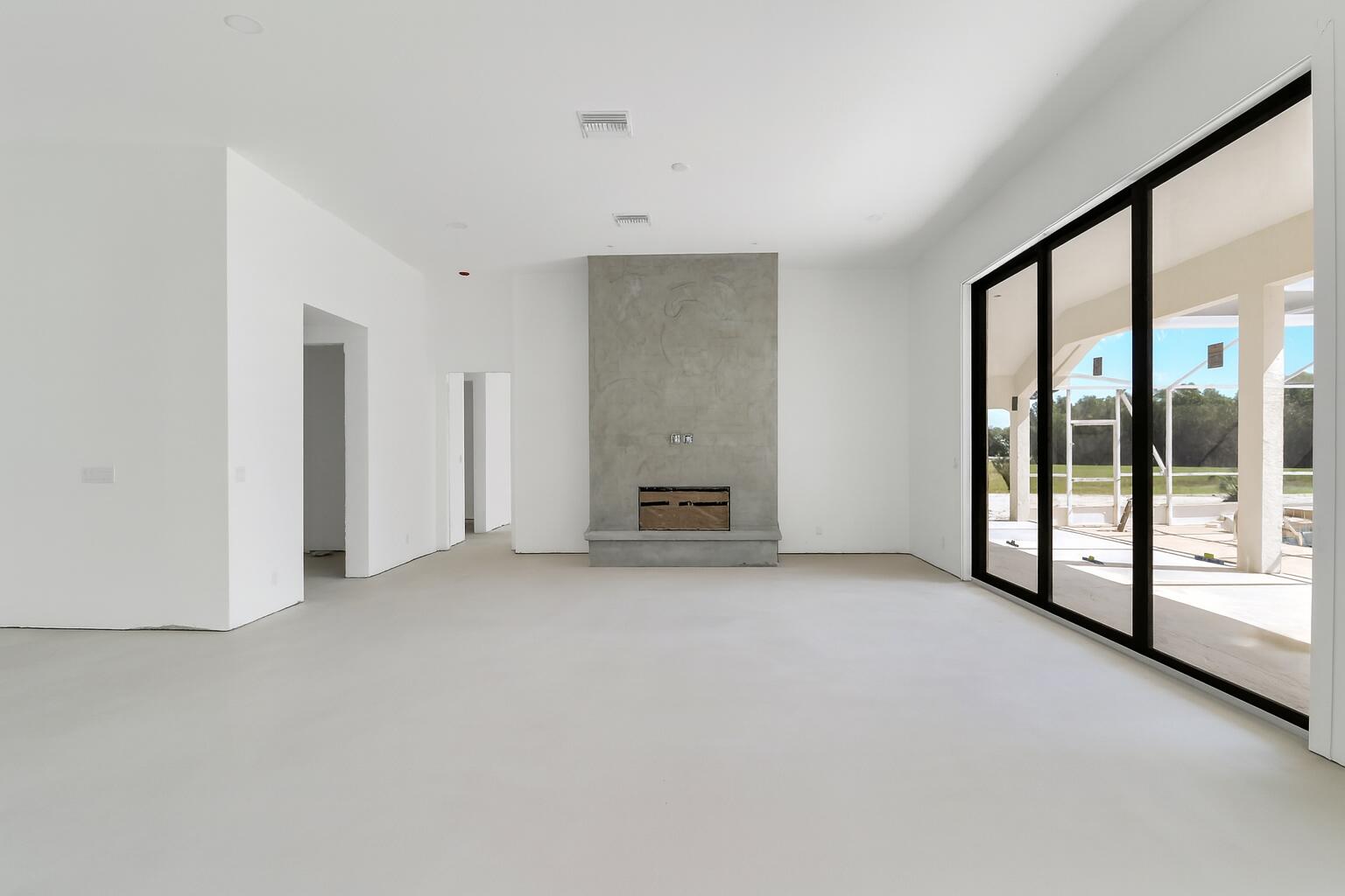 18851 Mack Dairy Road Jupiter, FL 33478 - Photo 19 of 47 a view of an empty room with a fireplace