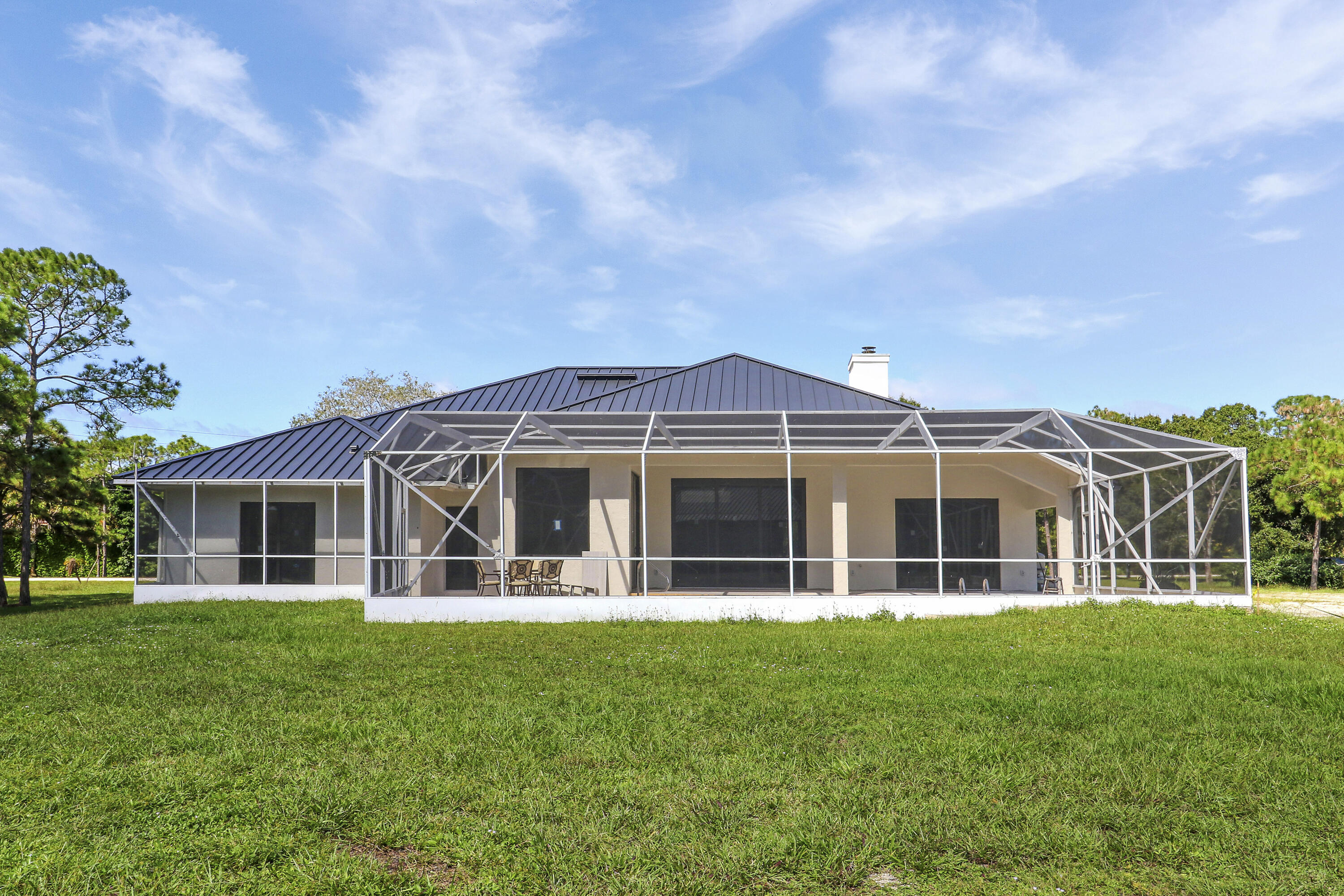 18851 Mack Dairy Road Jupiter, FL 33478 - Photo 24 of 47 a view of a house with a yard and potted plants