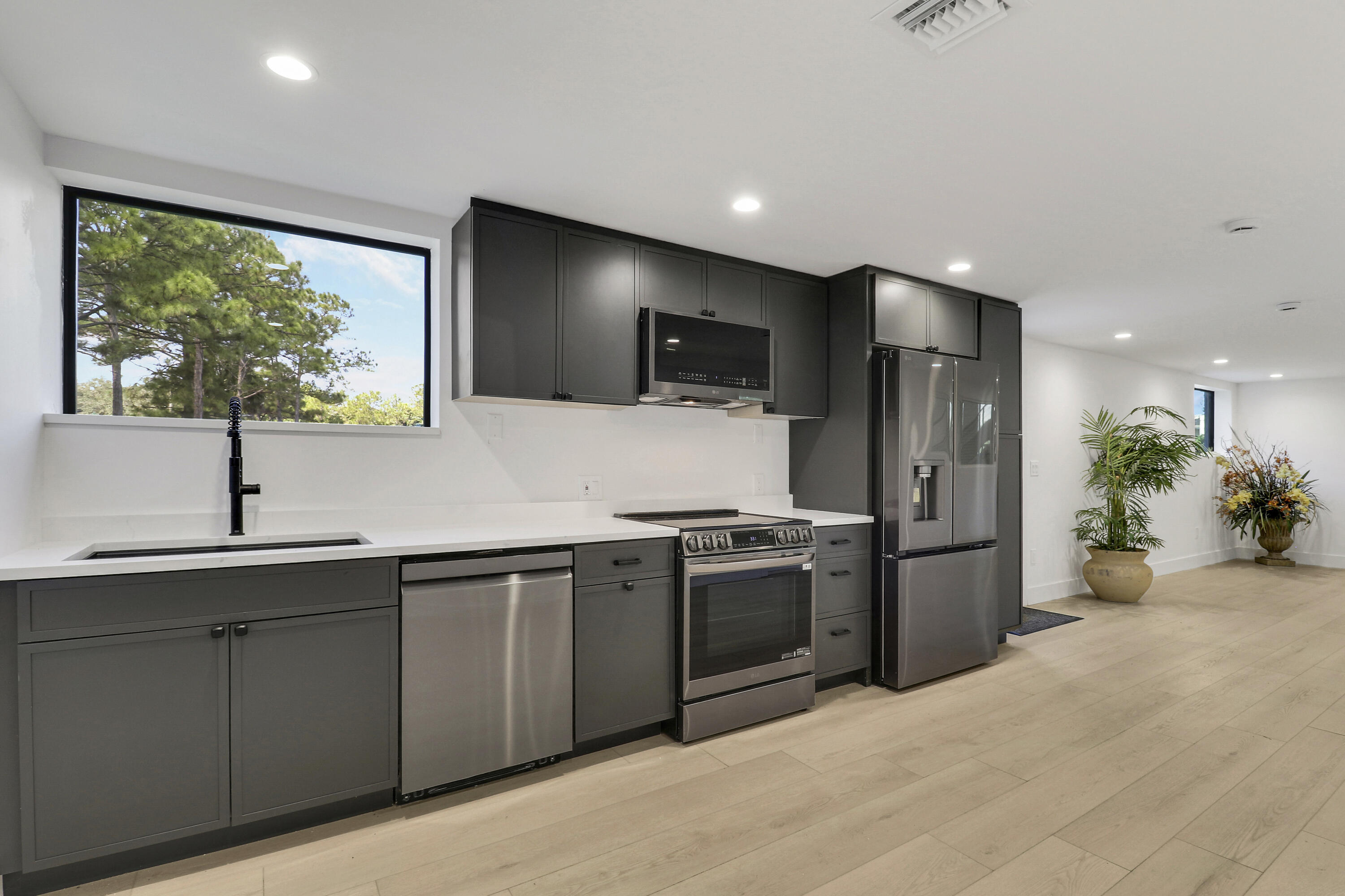 18851 Mack Dairy Road Jupiter, FL 33478 - Photo 25 of 47 a kitchen with stainless steel appliances a sink stove and refrigerator