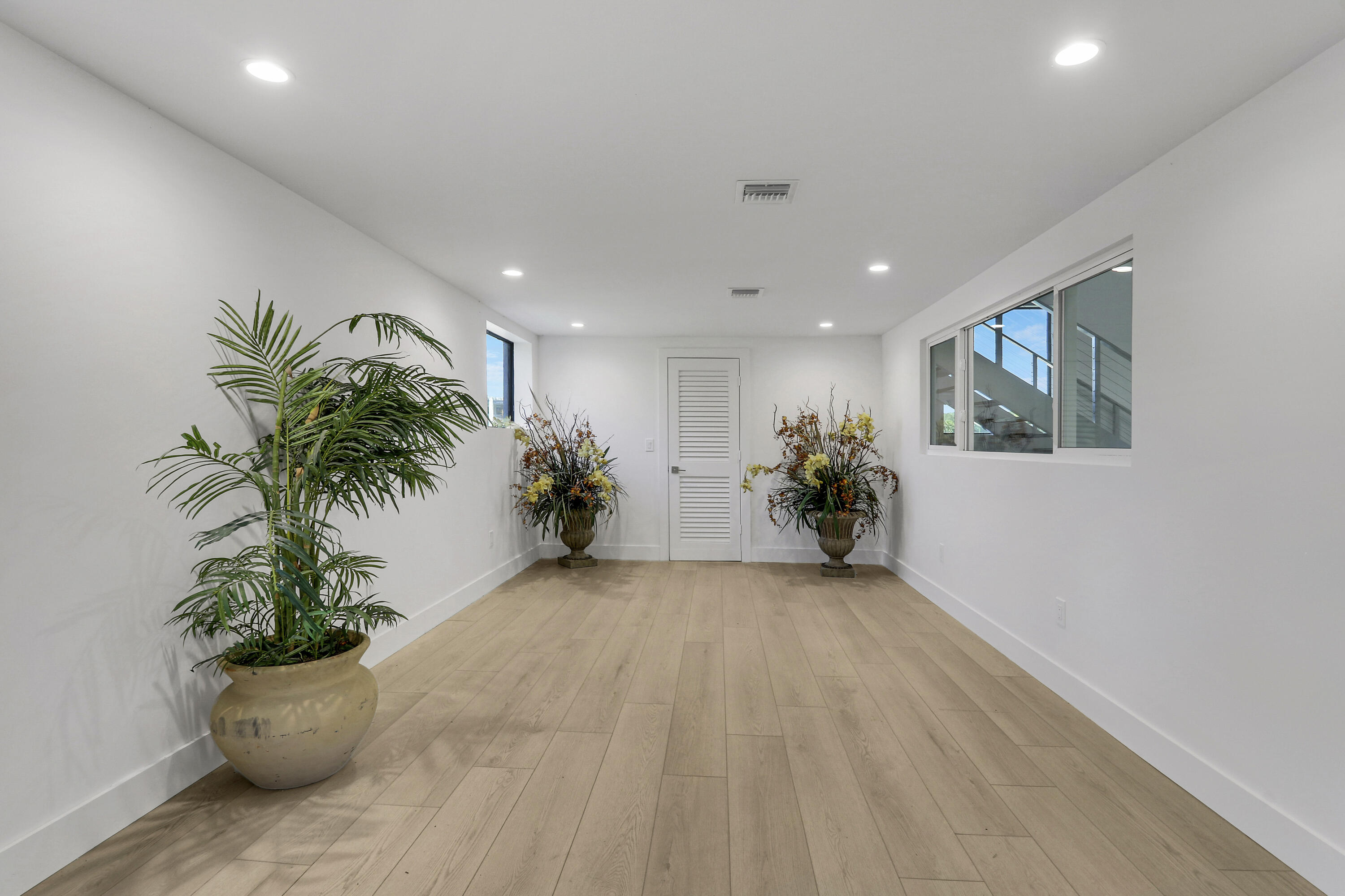 18851 Mack Dairy Road Jupiter, FL 33478 - Photo 26 of 47 a view of a hallway with a potted plant