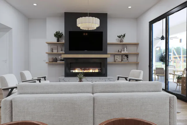a living room with furniture a fireplace and a flat screen tv