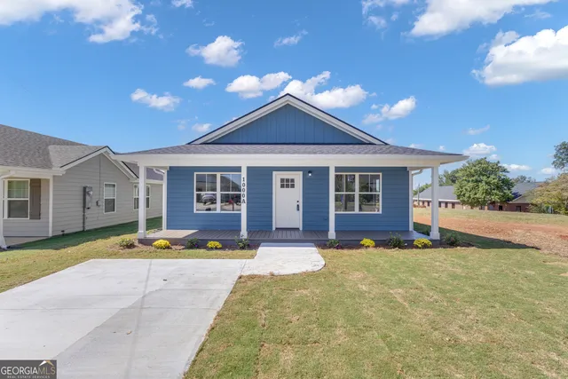 a front view of a house with a yard and porch