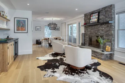 a living room with furniture a fireplace and a flat screen tv