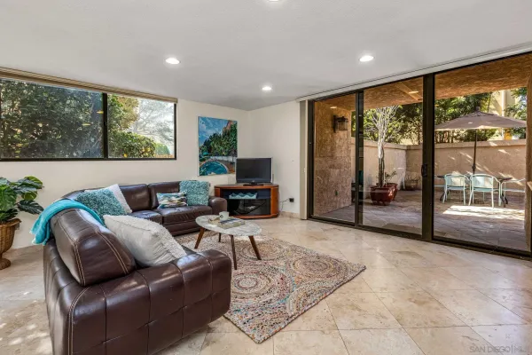 a living room with furniture large window and a flat screen tv
