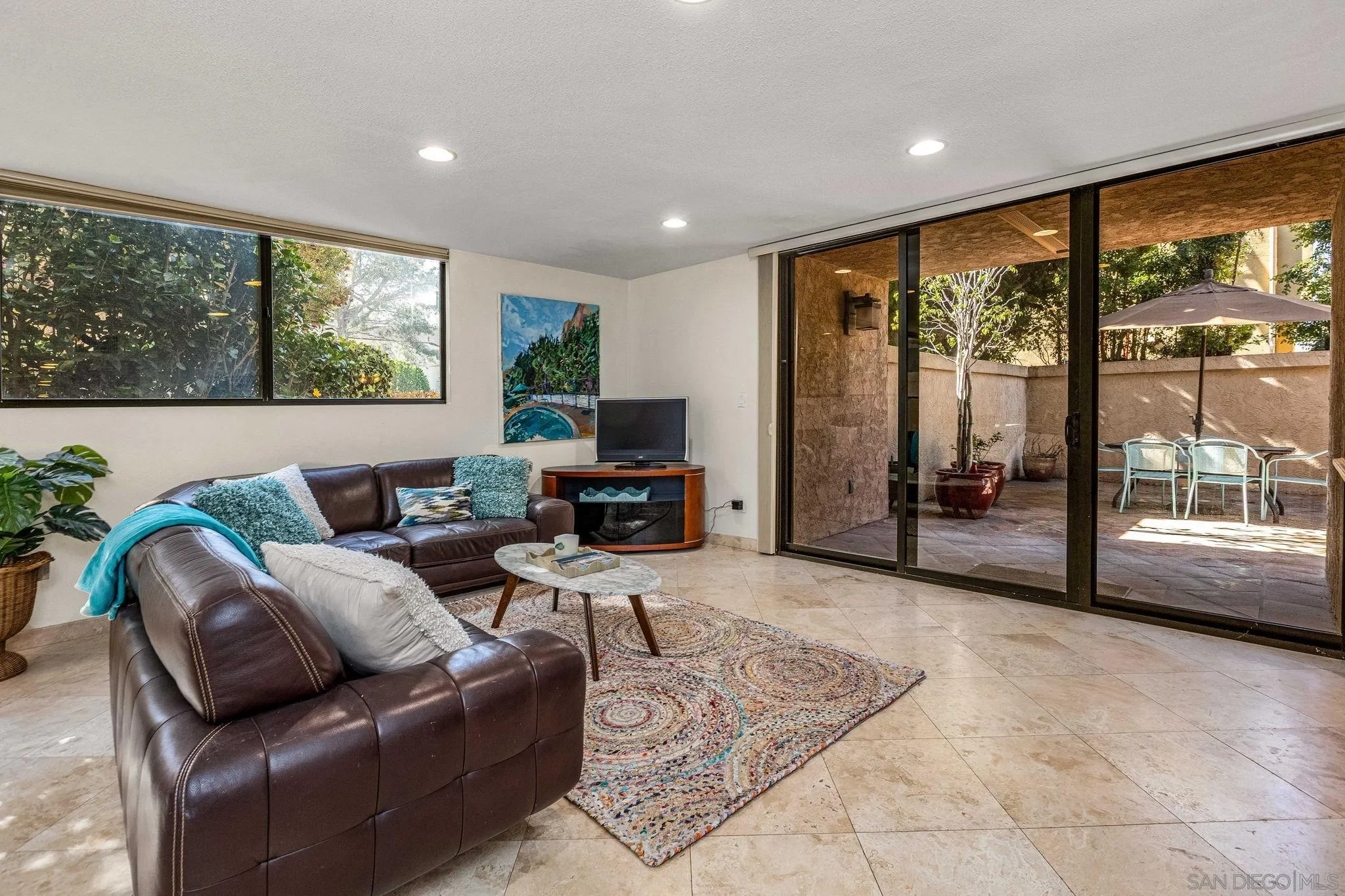 a living room with furniture large window and a flat screen tv