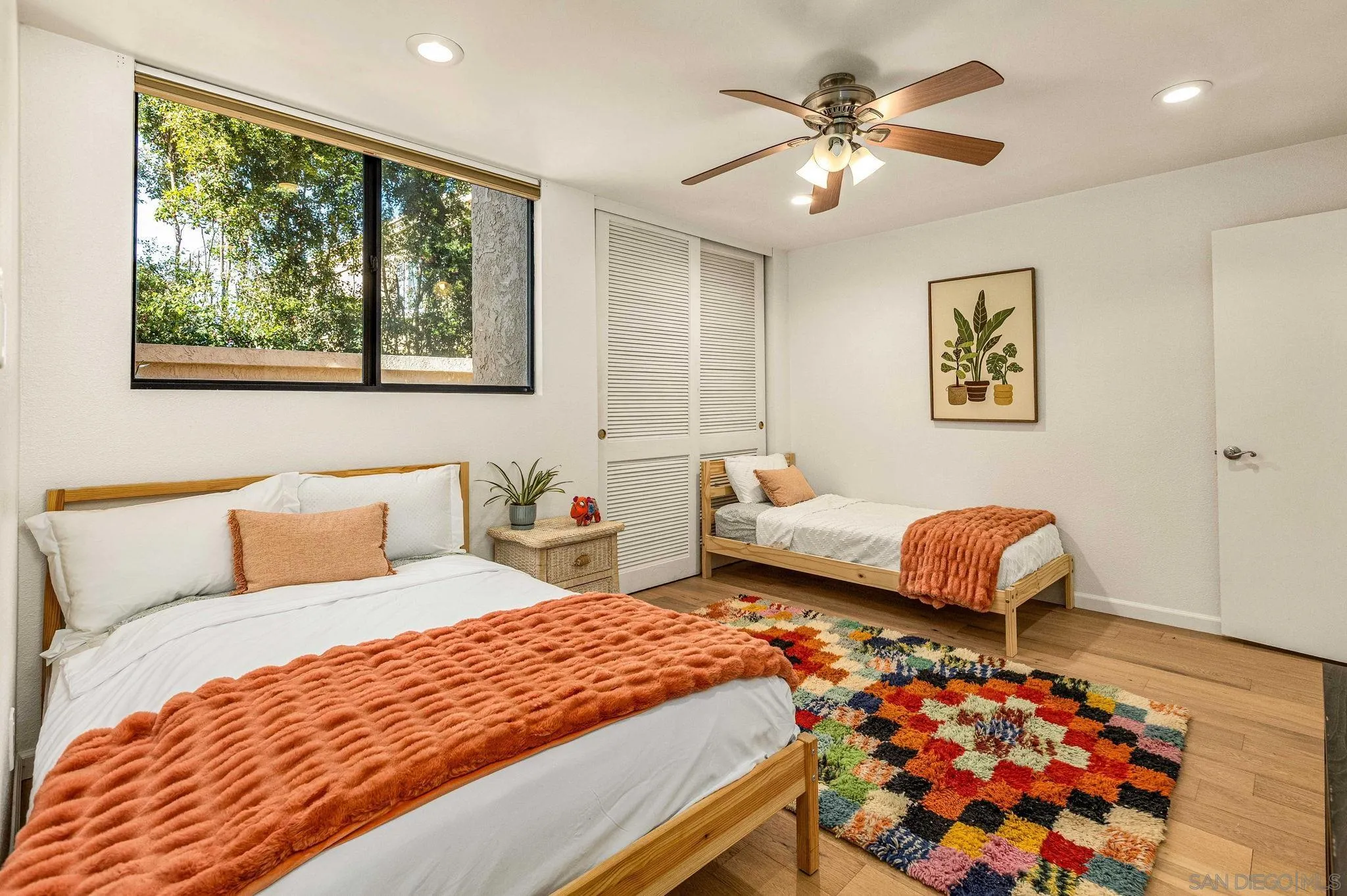 2420 Torrey Pines Road, Unit A104 La Jolla, CA 92037 - Photo 12 of 23 a bedroom with a bed mirror and window