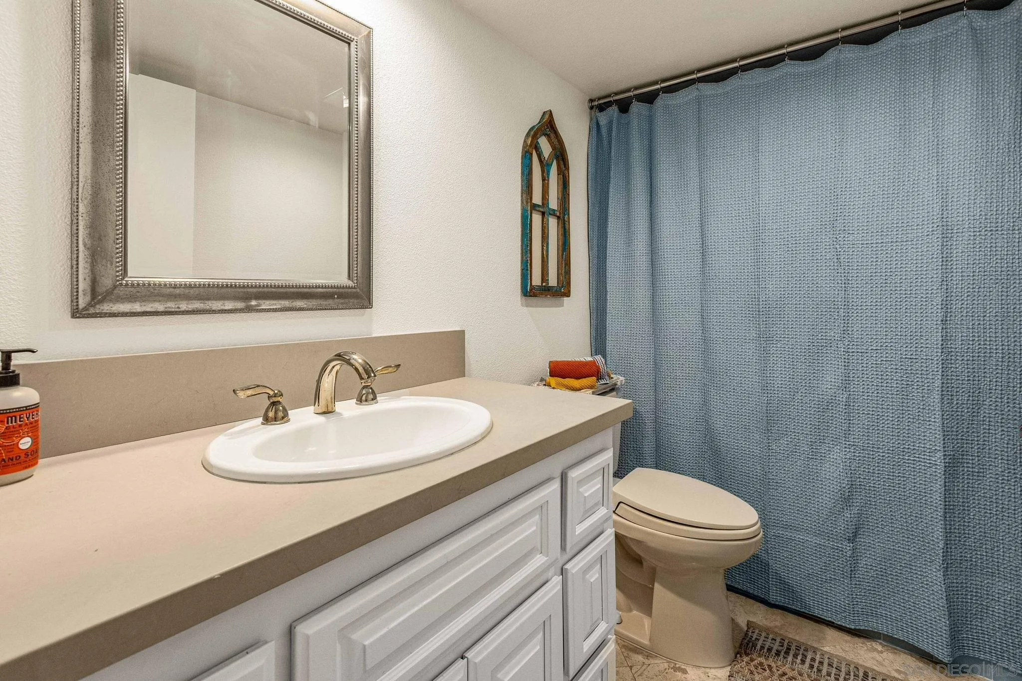 2420 Torrey Pines Road, Unit A104 La Jolla, CA 92037 - Photo 14 of 23 a bathroom with a sink a toilet and mirror