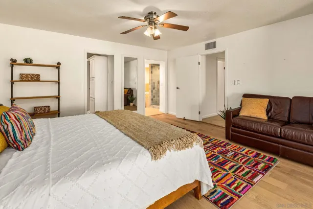 a bedroom with a bed and a couch