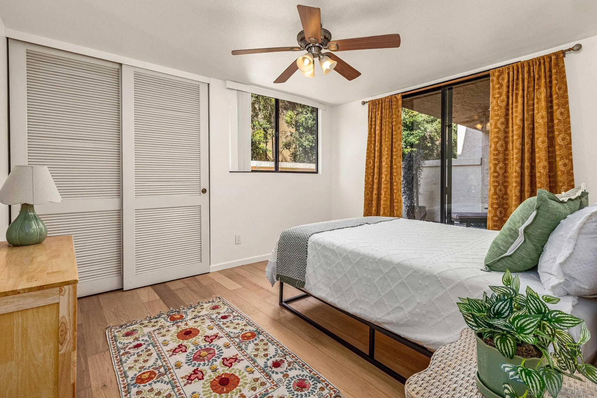 2420 Torrey Pines Road, Unit A104 La Jolla, CA 92037 - Photo 10 of 23 a bedroom with a bed window and walk in closet with wooden floor