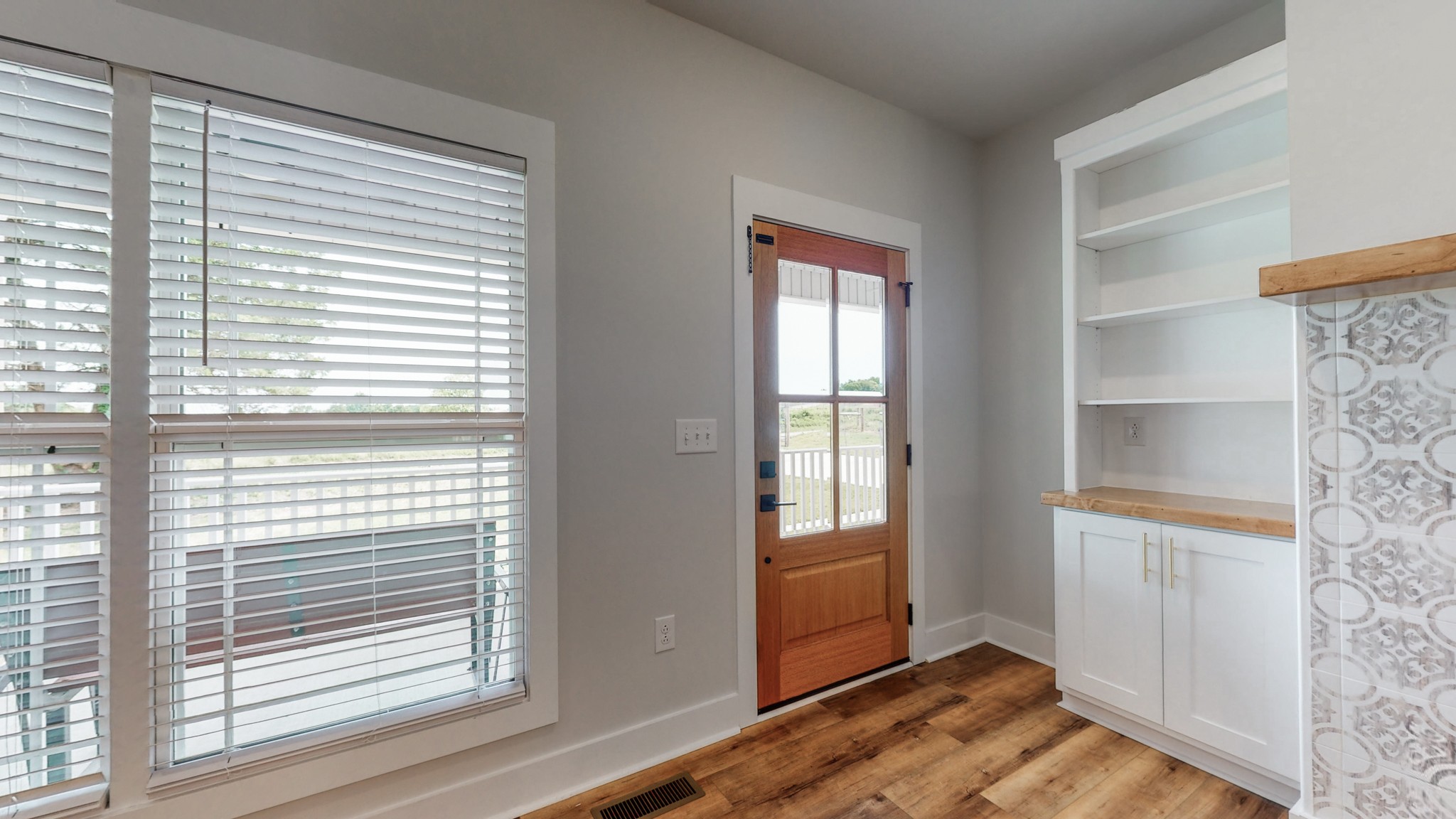 142 Philpot Road Ardmore, TN 38449 - Photo 20 of 51 a view of a bedroom with wooden floor and windows