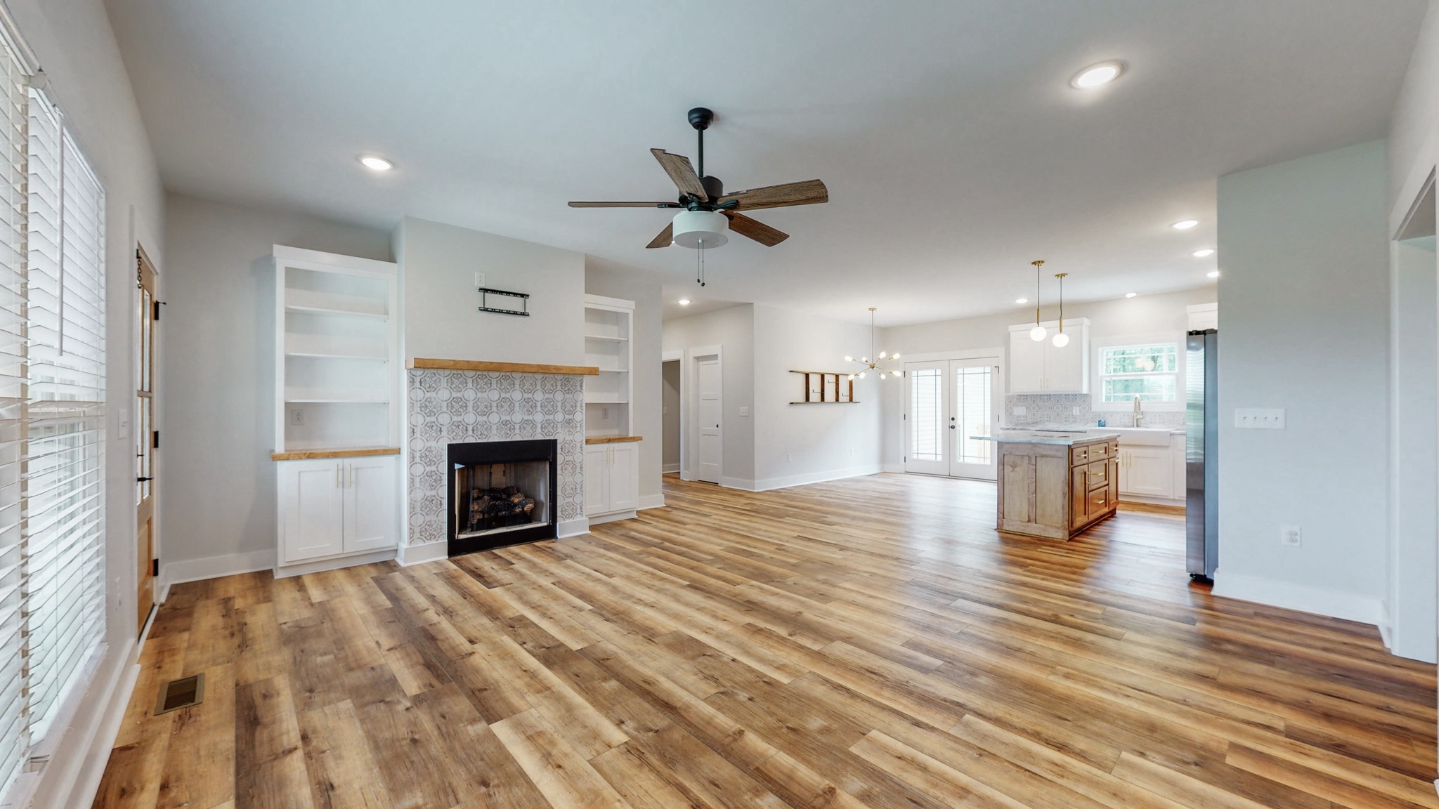 142 Philpot Road Ardmore, TN 38449 - Photo 21 of 51 a view of a livingroom with a fireplace a ceiling fan and wooden floor