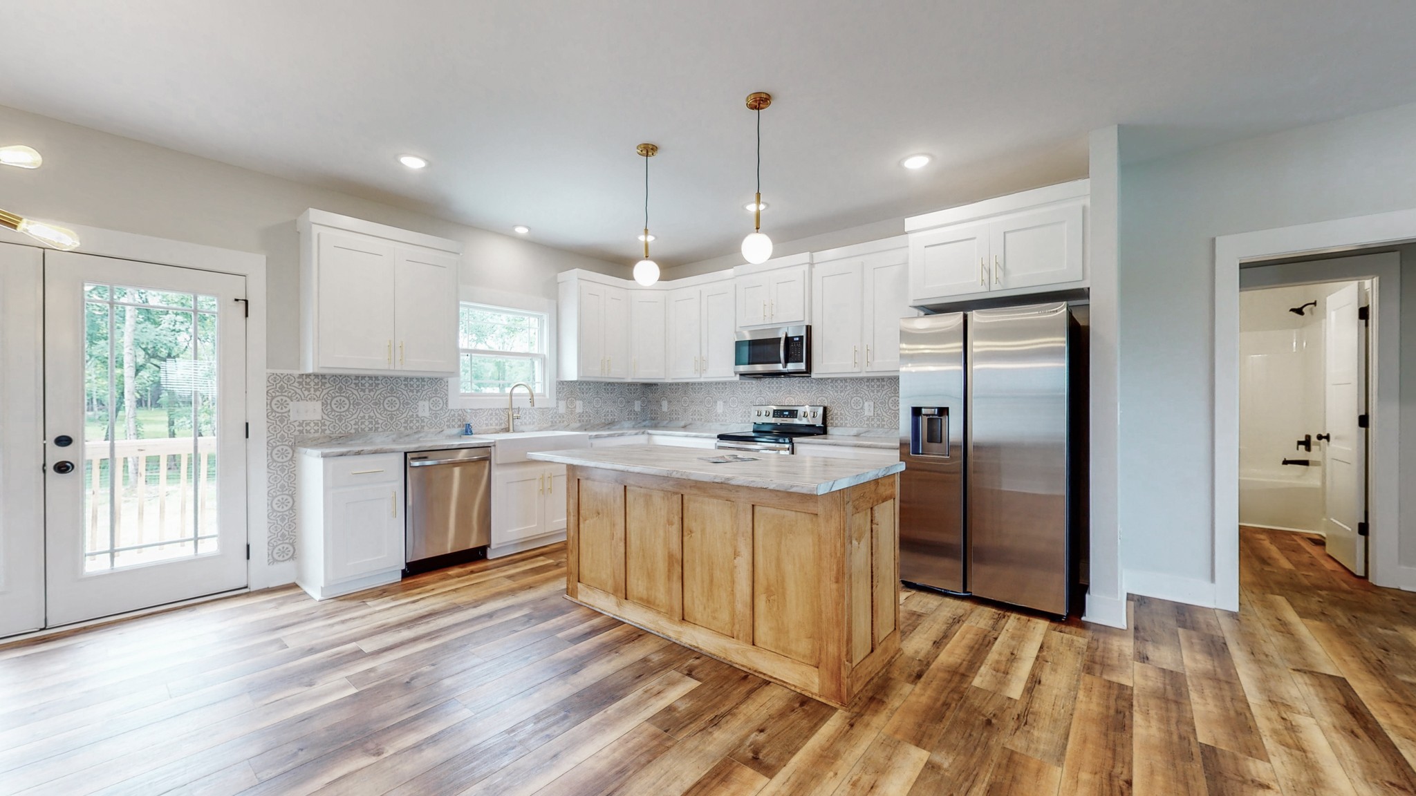 142 Philpot Road Ardmore, TN 38449 - Photo 25 of 51 a kitchen with stainless steel appliances granite countertop a refrigerator a sink dishwasher a stove and white countertops with wooden floor