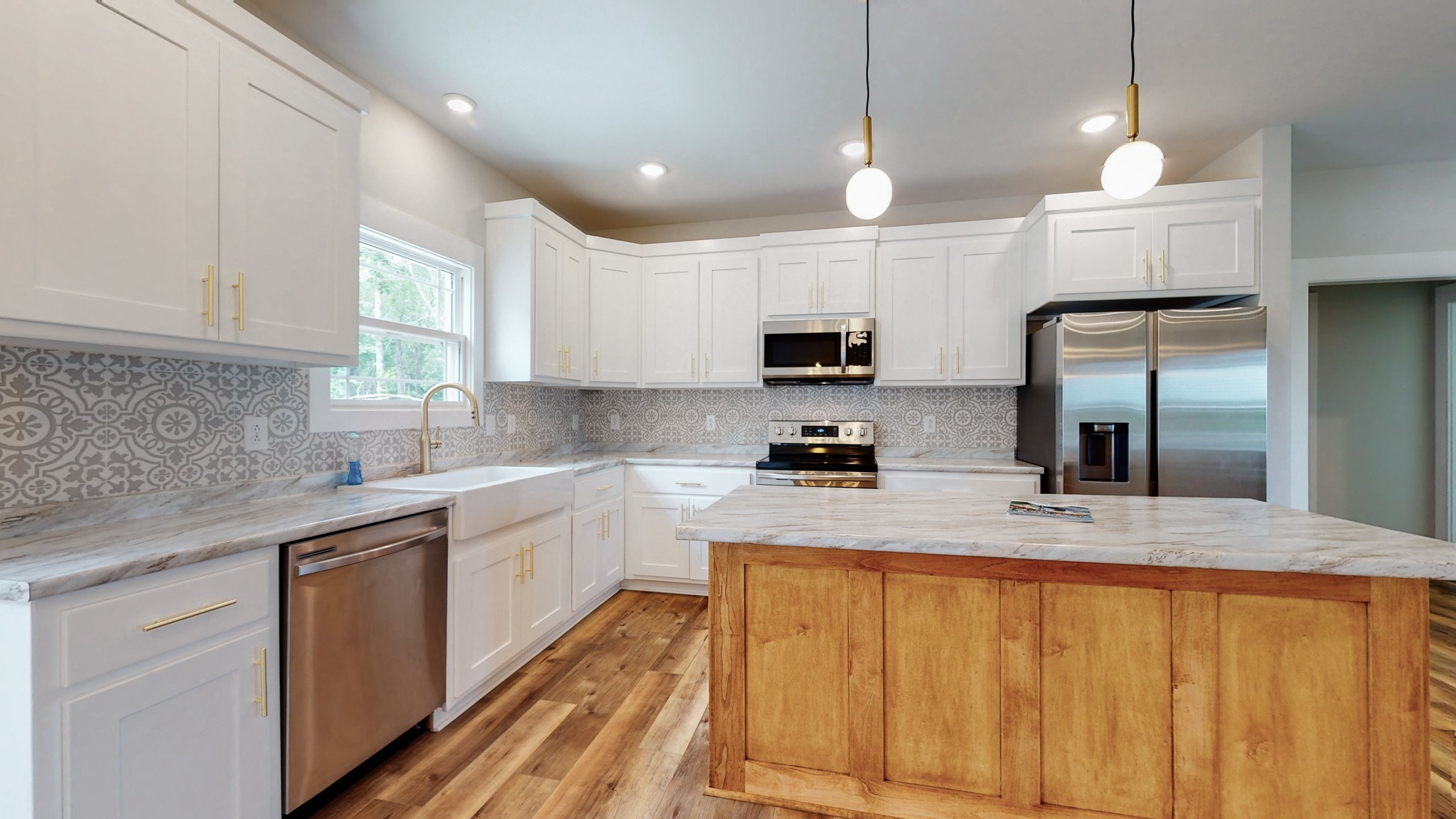 142 Philpot Road Ardmore, TN 38449 - Photo 29 of 51 a kitchen with kitchen island granite countertop a sink stainless steel appliances and white cabinets