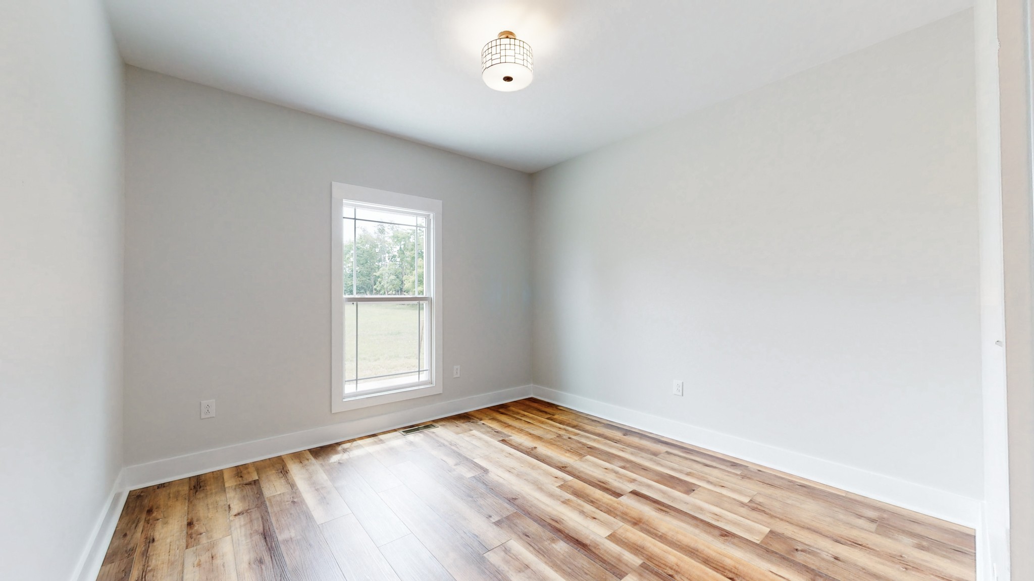 142 Philpot Road Ardmore, TN 38449 - Photo 40 of 51 an empty room with wooden floor cabinet and windows