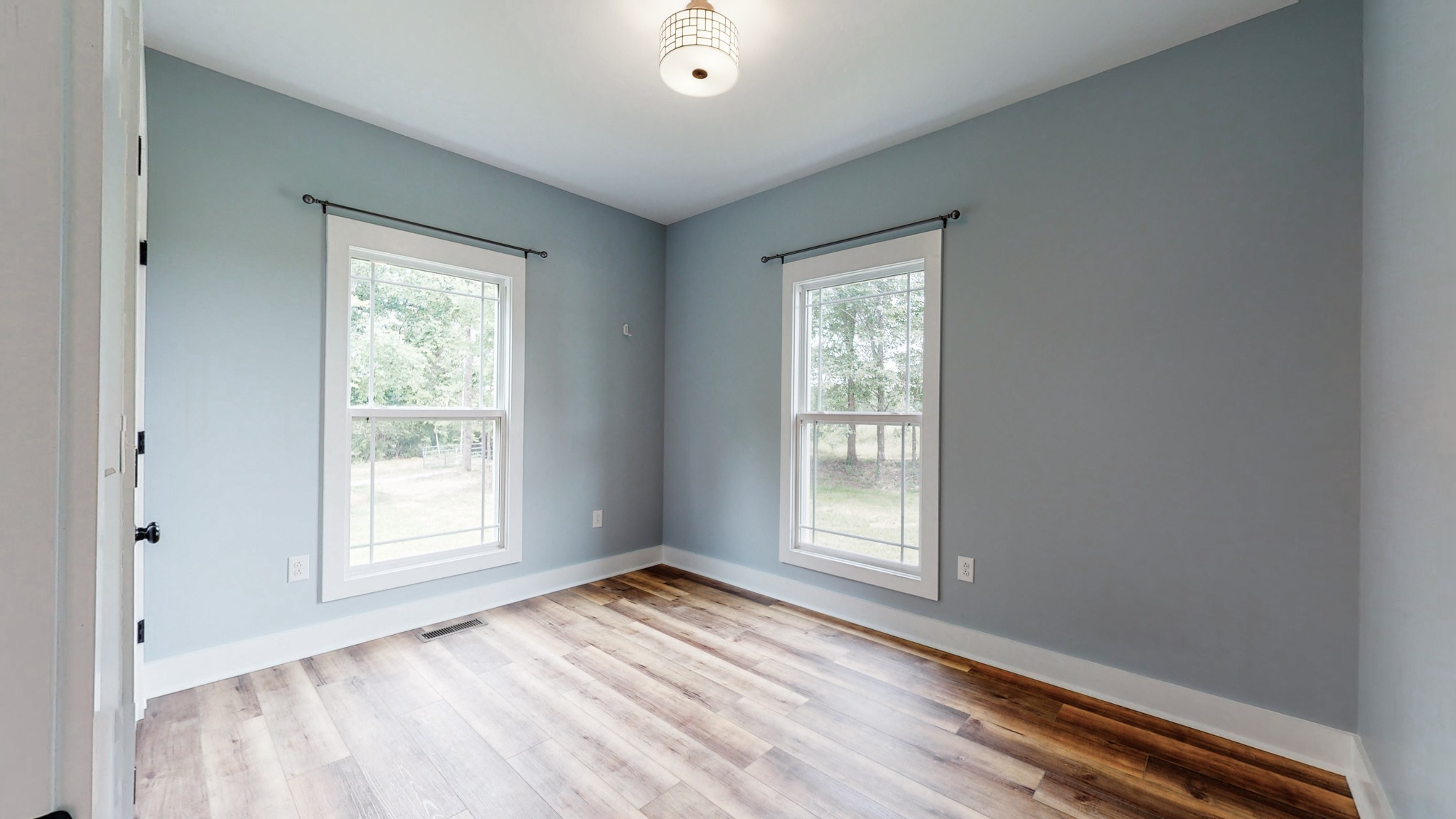 142 Philpot Road Ardmore, TN 38449 - Photo 46 of 51 an empty room with wooden floor and windows