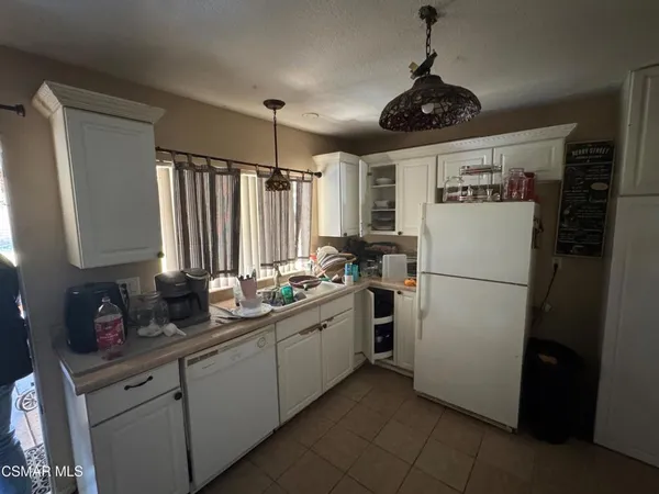 a kitchen with stainless steel appliances a refrigerator sink and cabinets