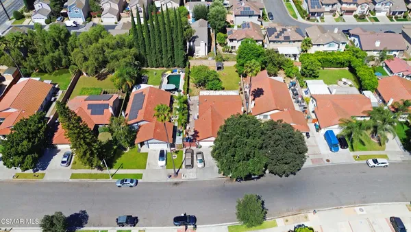 an aerial view of a house with a garden and swimming pool