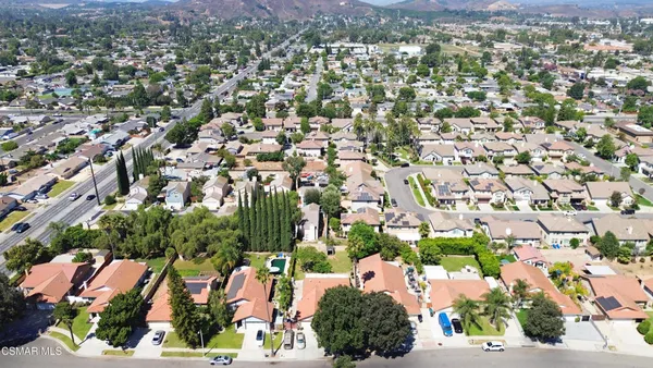 an aerial view of residential houses with outdoor space and street view