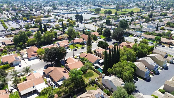an aerial view of residential houses with outdoor space