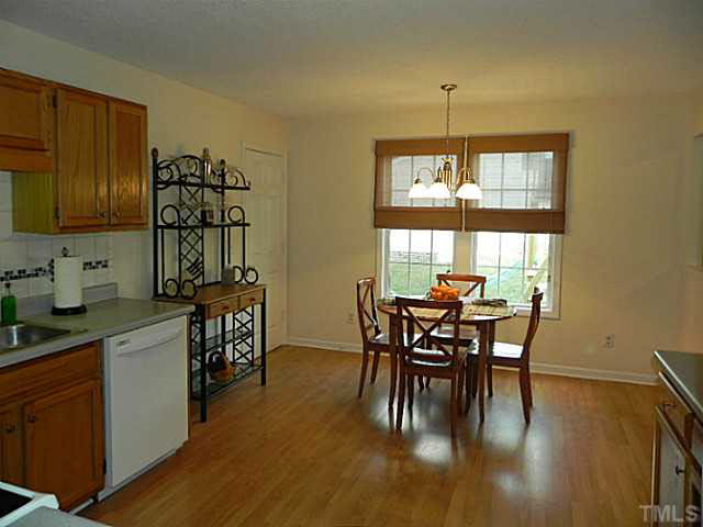 4517 Whistling Way Raleigh, NC 27616 - Photo 12 of 24 a dining room with furniture and wooden floor