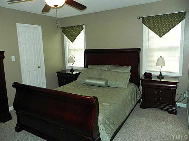 4517 Whistling Way Raleigh, NC 27616 - Photo 13 of 24 a bedroom with a bed and a window