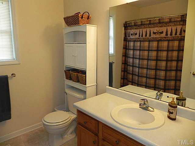 4517 Whistling Way Raleigh, NC 27616 - Photo 15 of 24 a bathroom with a sink toilet and shower