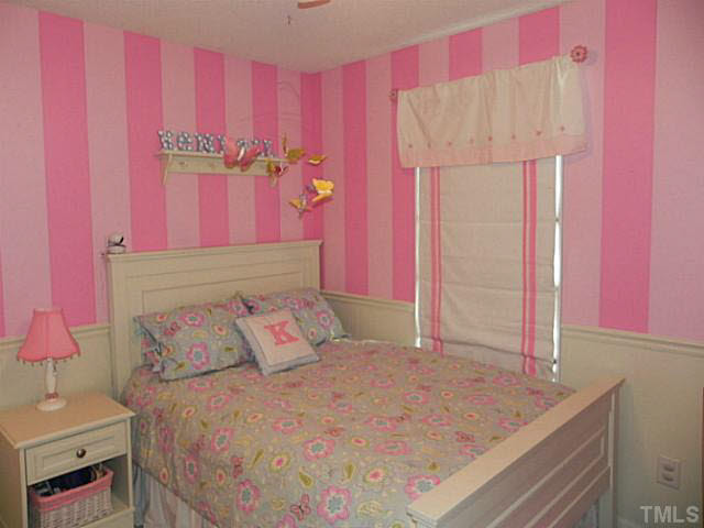 4517 Whistling Way Raleigh, NC 27616 - Photo 19 of 24 a bedroom with a bed and a dresser