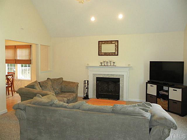 4517 Whistling Way Raleigh, NC 27616 - Photo 5 of 24 a living room with furniture and a flat screen tv