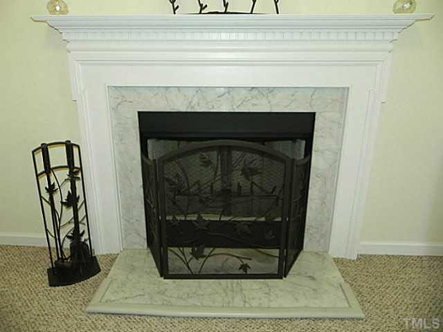 4517 Whistling Way Raleigh, NC 27616 - Photo 6 of 24 a living room with a fireplace and a rug