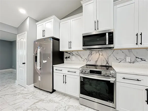 a view of a kitchen with a sink and microwave