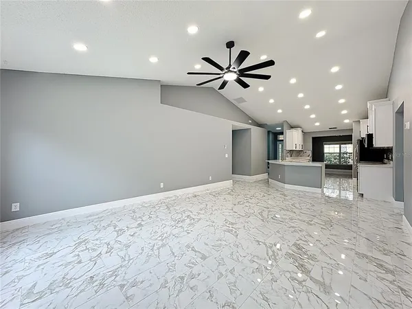a view of an empty room and wooden floor