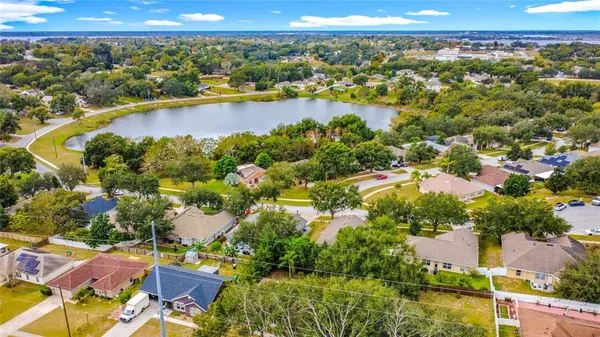 an aerial view of residential houses with outdoor space and swimming pool