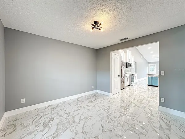 a kitchen with a sink cabinets and wooden floor