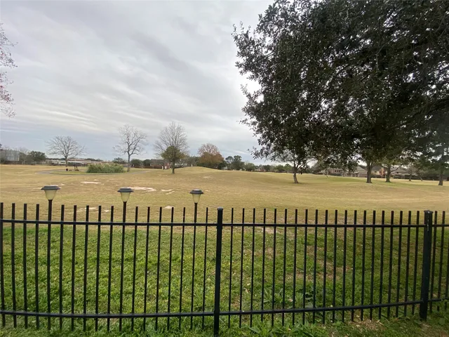 a view of outdoor space with iron fence