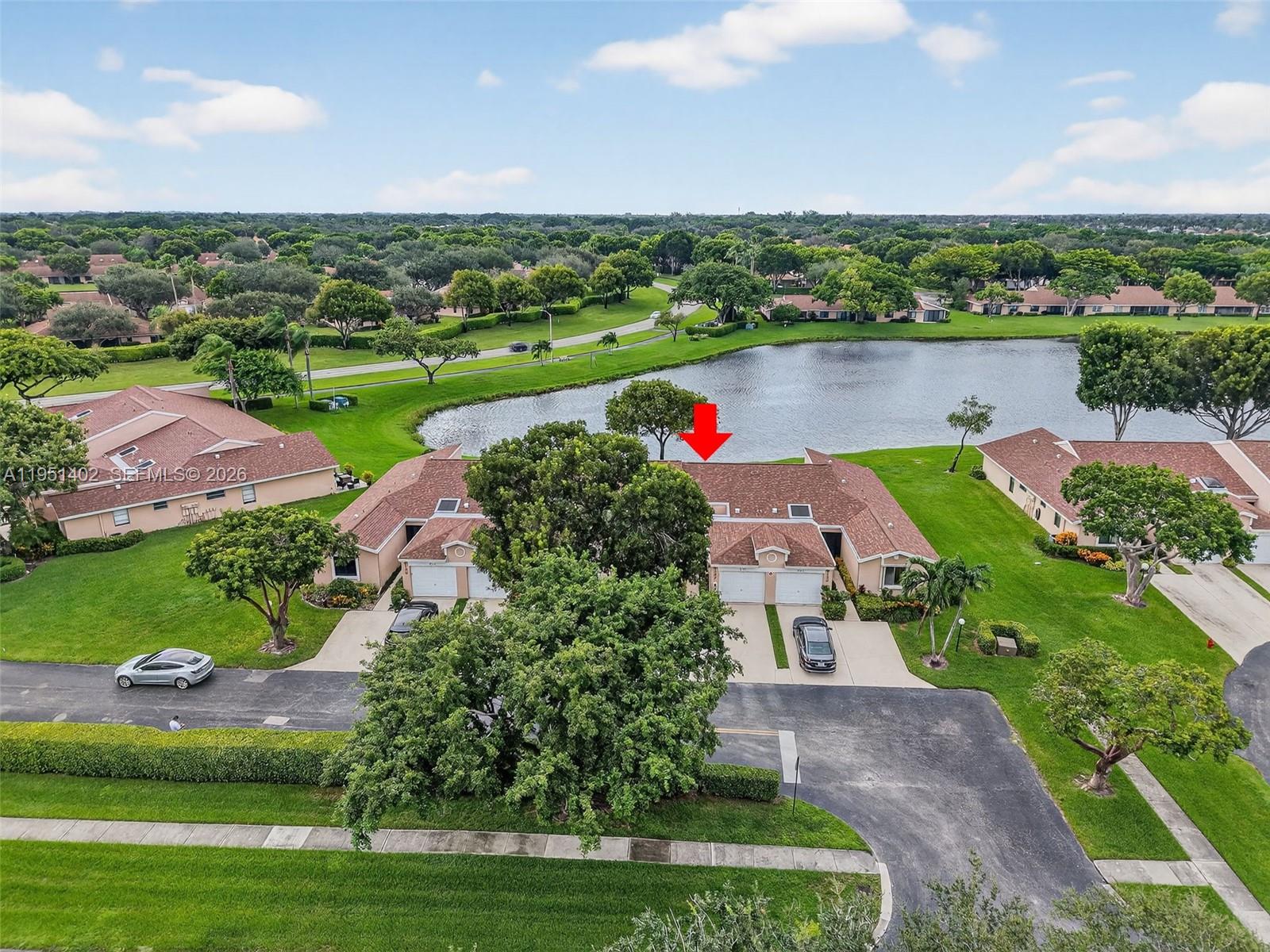 8127 Songbird Terrace Boca Raton, FL 33496 - Photo 1 of 65 an aerial view of a house with a garden and lake view