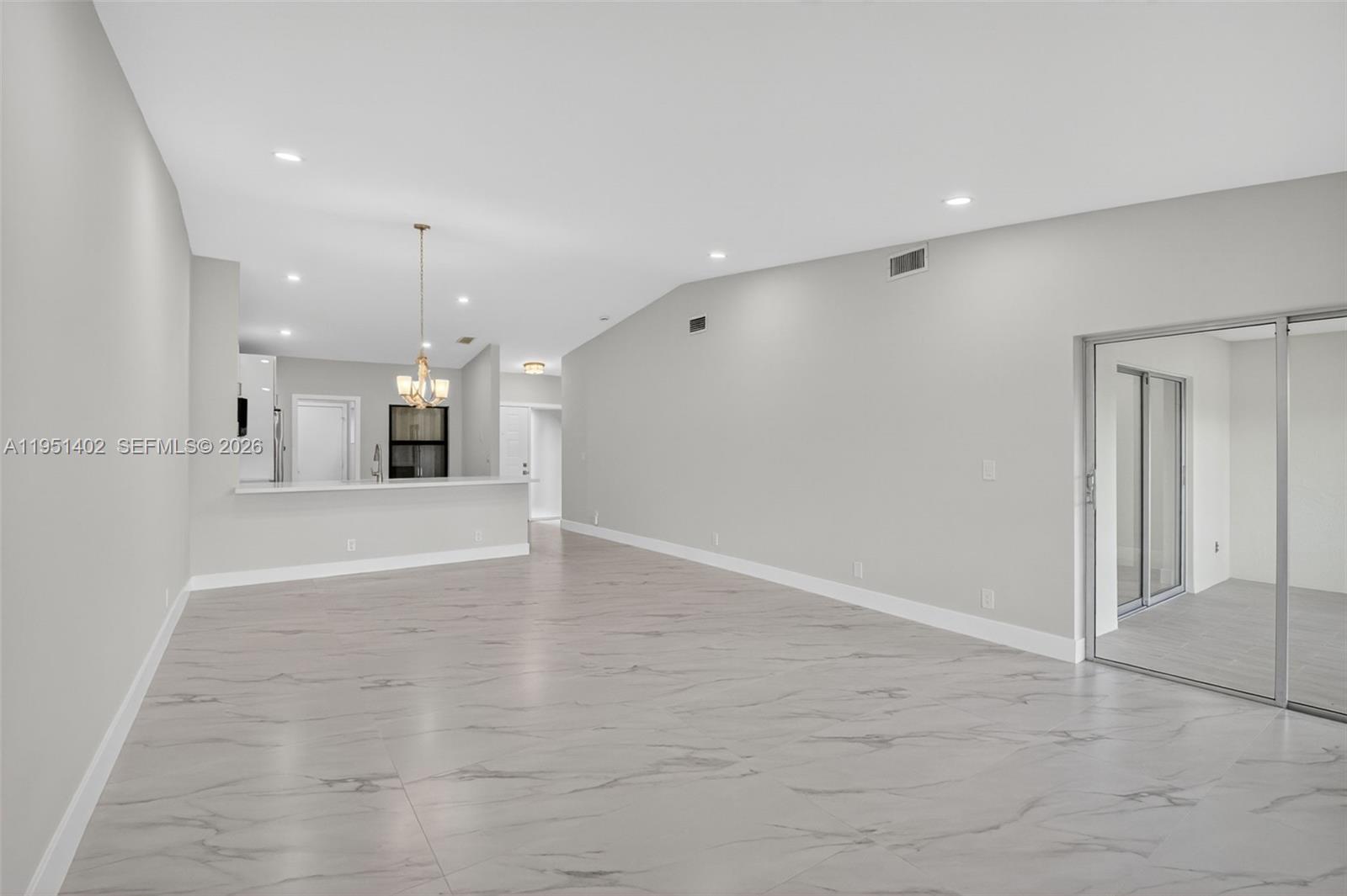 8127 Songbird Terrace Boca Raton, FL 33496 - Photo 12 of 65 a view of an empty room with kitchen