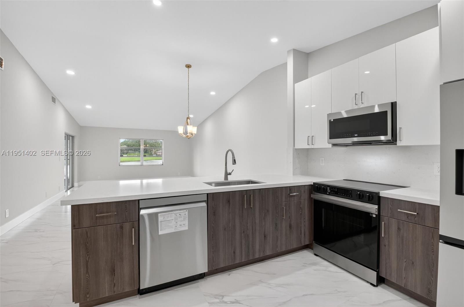 8127 Songbird Terrace Boca Raton, FL 33496 - Photo 16 of 65 a kitchen with a sink stove and microwave