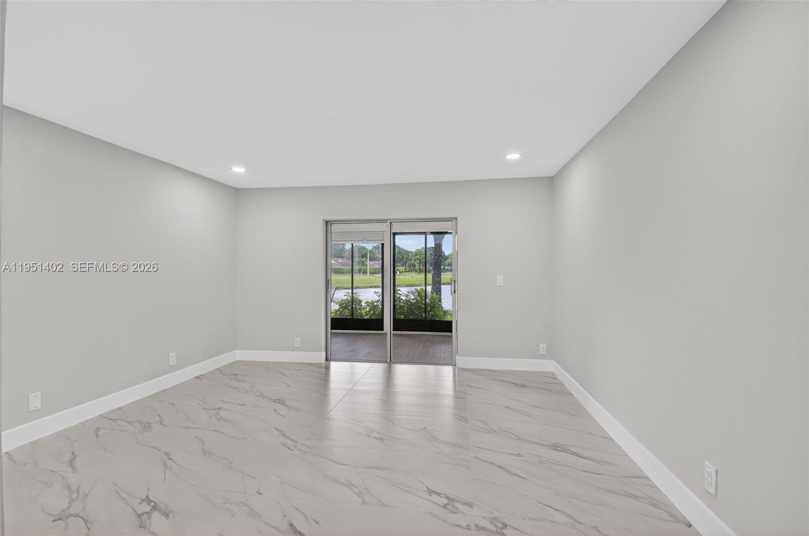 8127 Songbird Terrace Boca Raton, FL 33496 - Photo 20 of 65 wooden floor in an empty room with a window