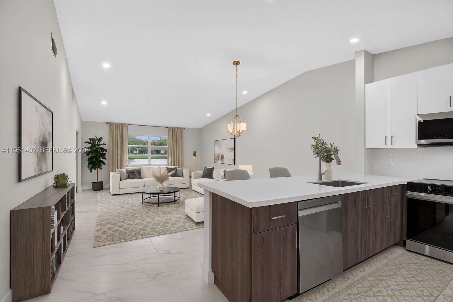 8127 Songbird Terrace Boca Raton, FL 33496 - Photo 2 of 65 a kitchen with sink and view of living room
