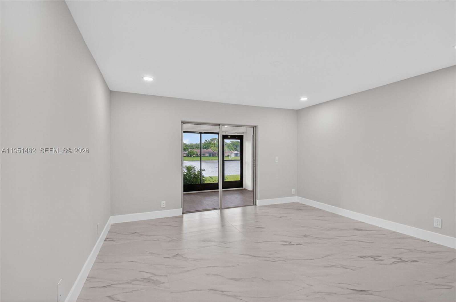 8127 Songbird Terrace Boca Raton, FL 33496 - Photo 21 of 65 wooden floor in an empty room with a window