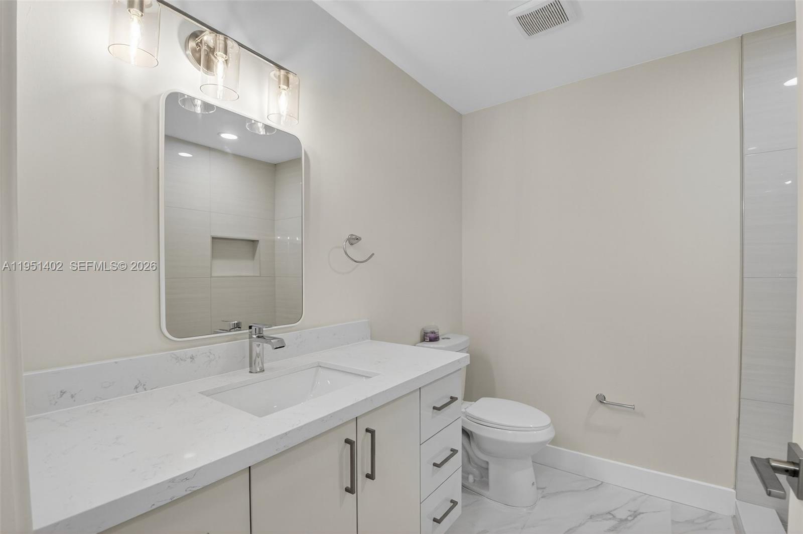 8127 Songbird Terrace Boca Raton, FL 33496 - Photo 27 of 65 a bathroom with a sink toilet and a mirror