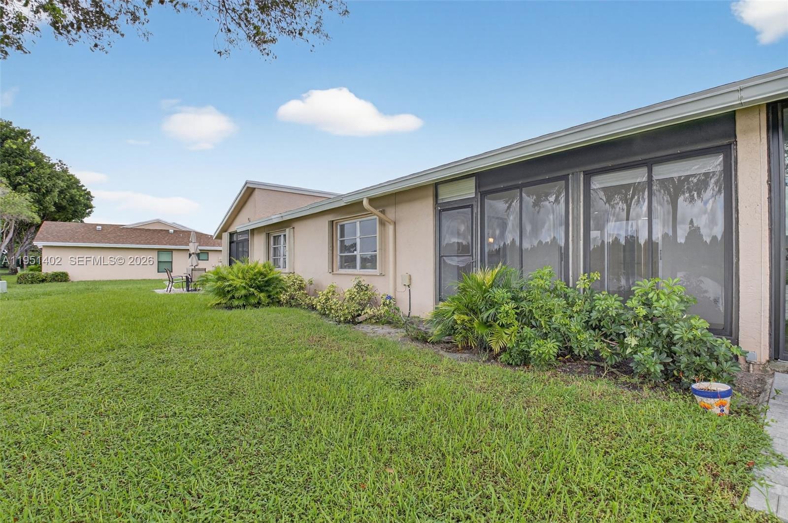 8127 Songbird Terrace Boca Raton, FL 33496 - Photo 32 of 65 a view of a house with porch and garden