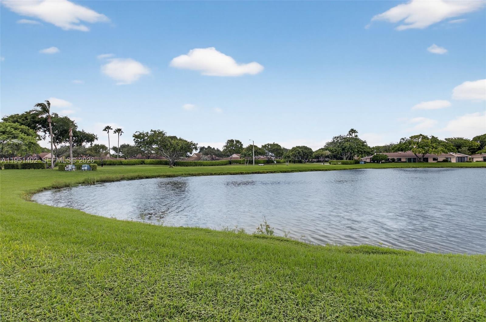 8127 Songbird Terrace Boca Raton, FL 33496 - Photo 34 of 65 a view of a lake with a big yard and large trees