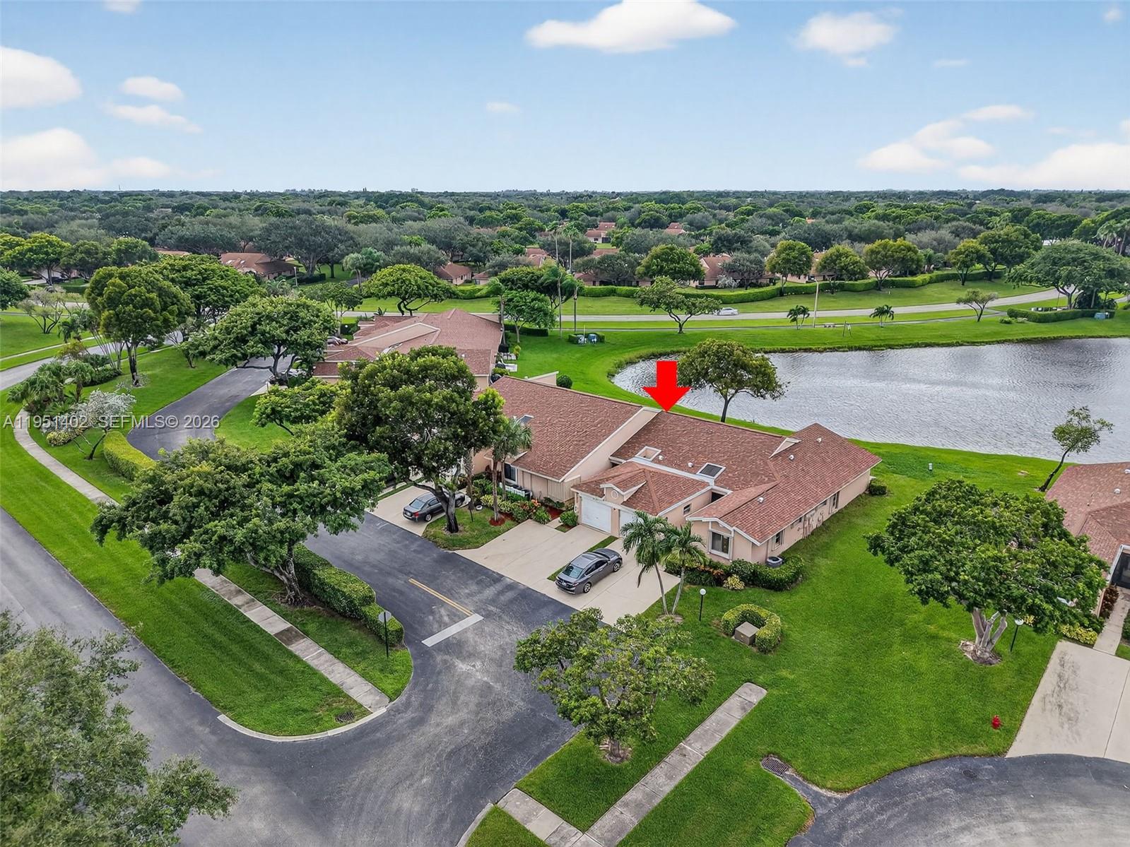 8127 Songbird Terrace Boca Raton, FL 33496 - Photo 38 of 65 an aerial view of a house with a garden and lake view