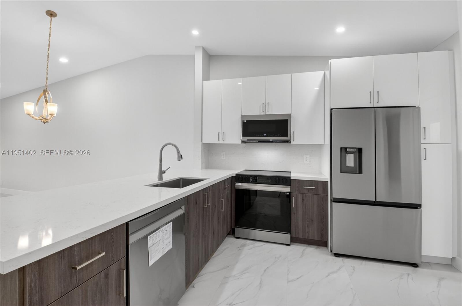 8127 Songbird Terrace Boca Raton, FL 33496 - Photo 7 of 65 a kitchen with stainless steel appliances granite countertop a refrigerator a sink and a stove