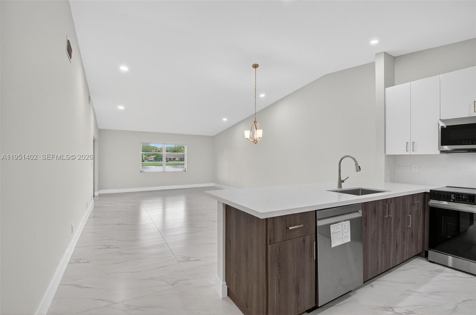8127 Songbird Terrace Boca Raton, FL 33496 - Photo 8 of 65 a kitchen with a sink and cabinets