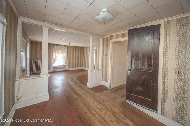 an empty room with windows and closet