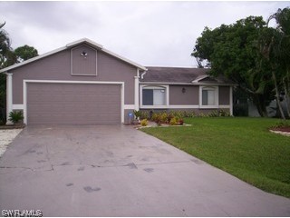 8056 Pelican Road Fort Myers, FL 33967 - Photo 1 of 5 front view of a house with a yard