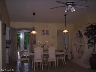 8056 Pelican Road Fort Myers, FL 33967 - Photo 4 of 5 a dining room with furniture and chandelier
